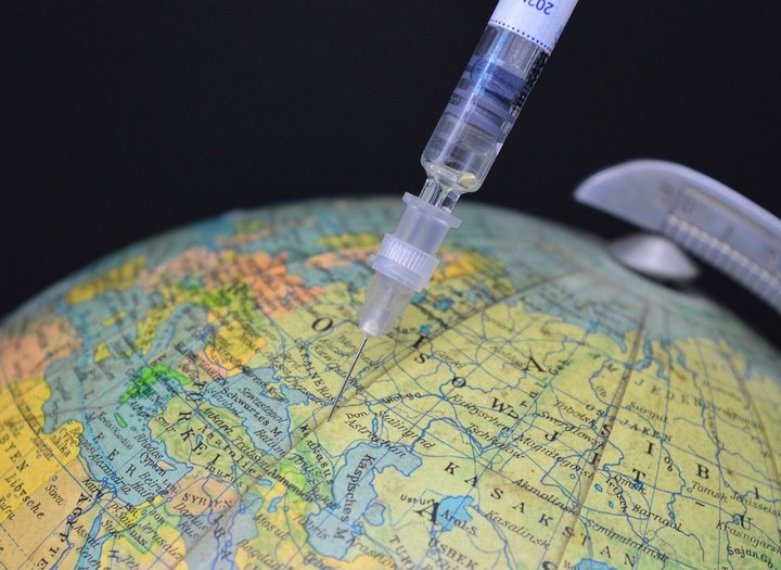 Syringe injecting vaccine into a globe