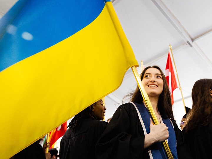 Salome Mikadze at graduation carrying the Ukrainian flag