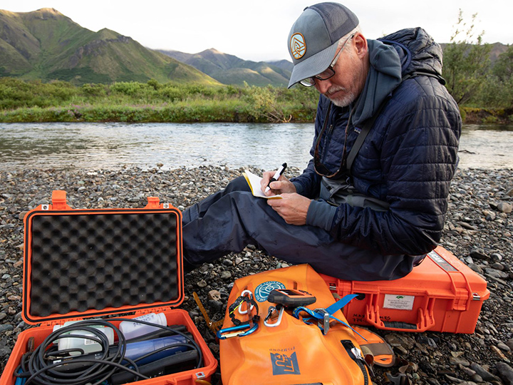 Max Holmes conducting field work