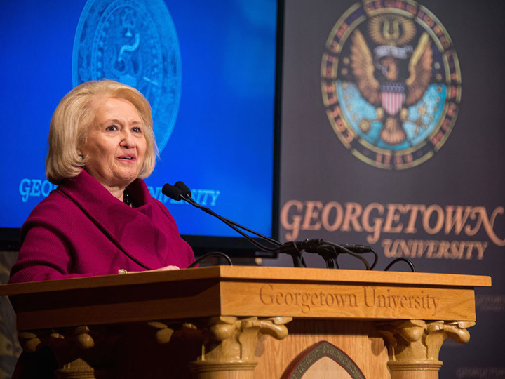 Melanne Verveer speaking at a podium at Georgetown