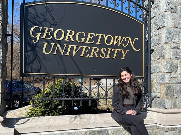 Emily Prest in front of the Georgetown sign