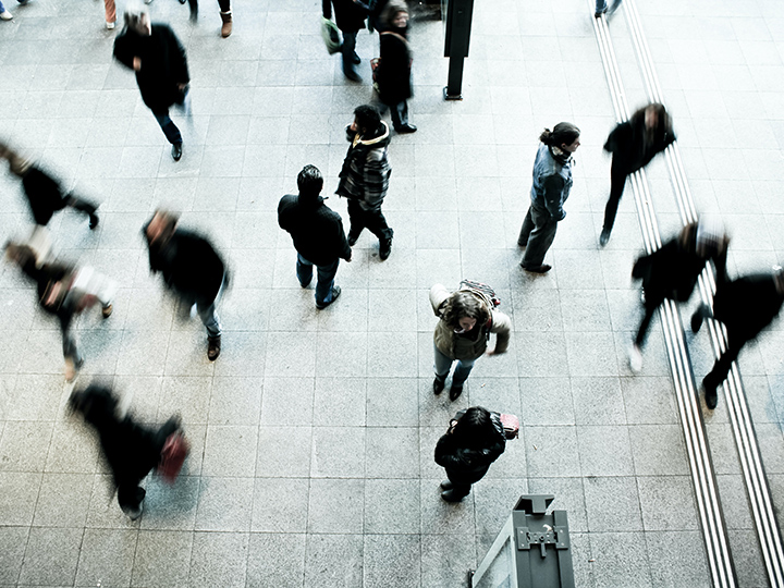 A person standing in a crowd, while everyone around him is moving