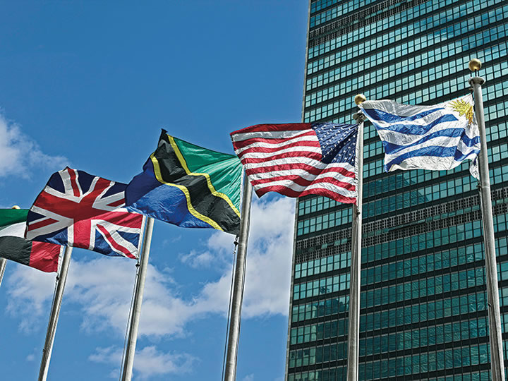 Flags flying in front of the United Nations building.