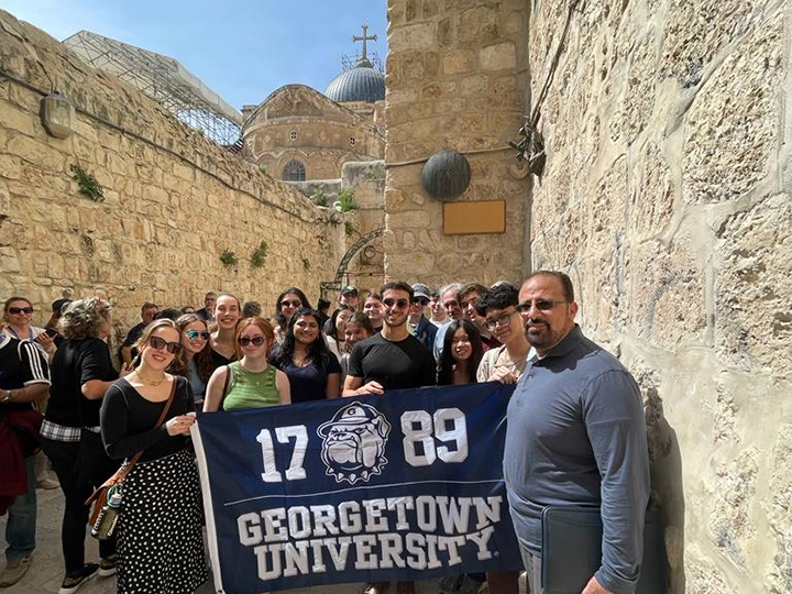 The Jerusalem and the Challenge of Peace class poses for a group picture outside the Church of the Holy Sepulchre