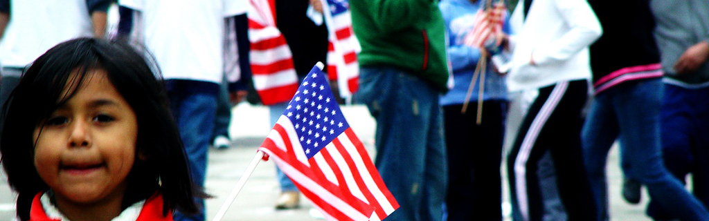 A young girl holds an American flag during a stand for immigrants' rights in Chicago, May 1, 2006
