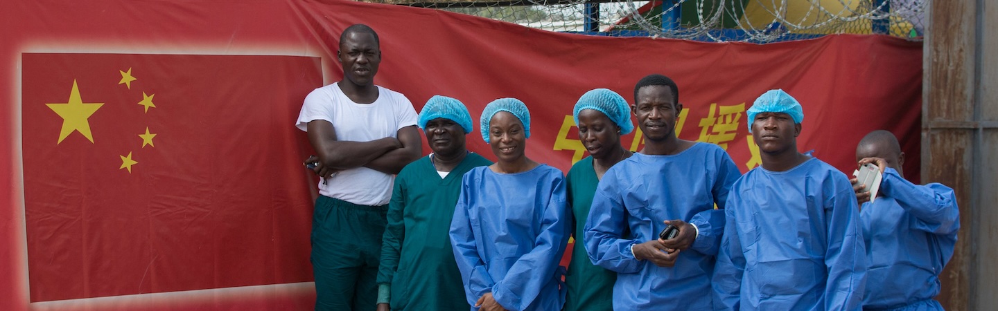 Ebola Response workers stand outside the Chinese Ebola treatment unit in Monrovia, Liberia. UNMEER/Simon Ruf/Flickr