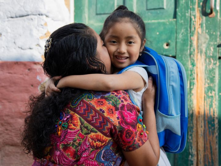 A mother hugs her daughter in Guatemala.