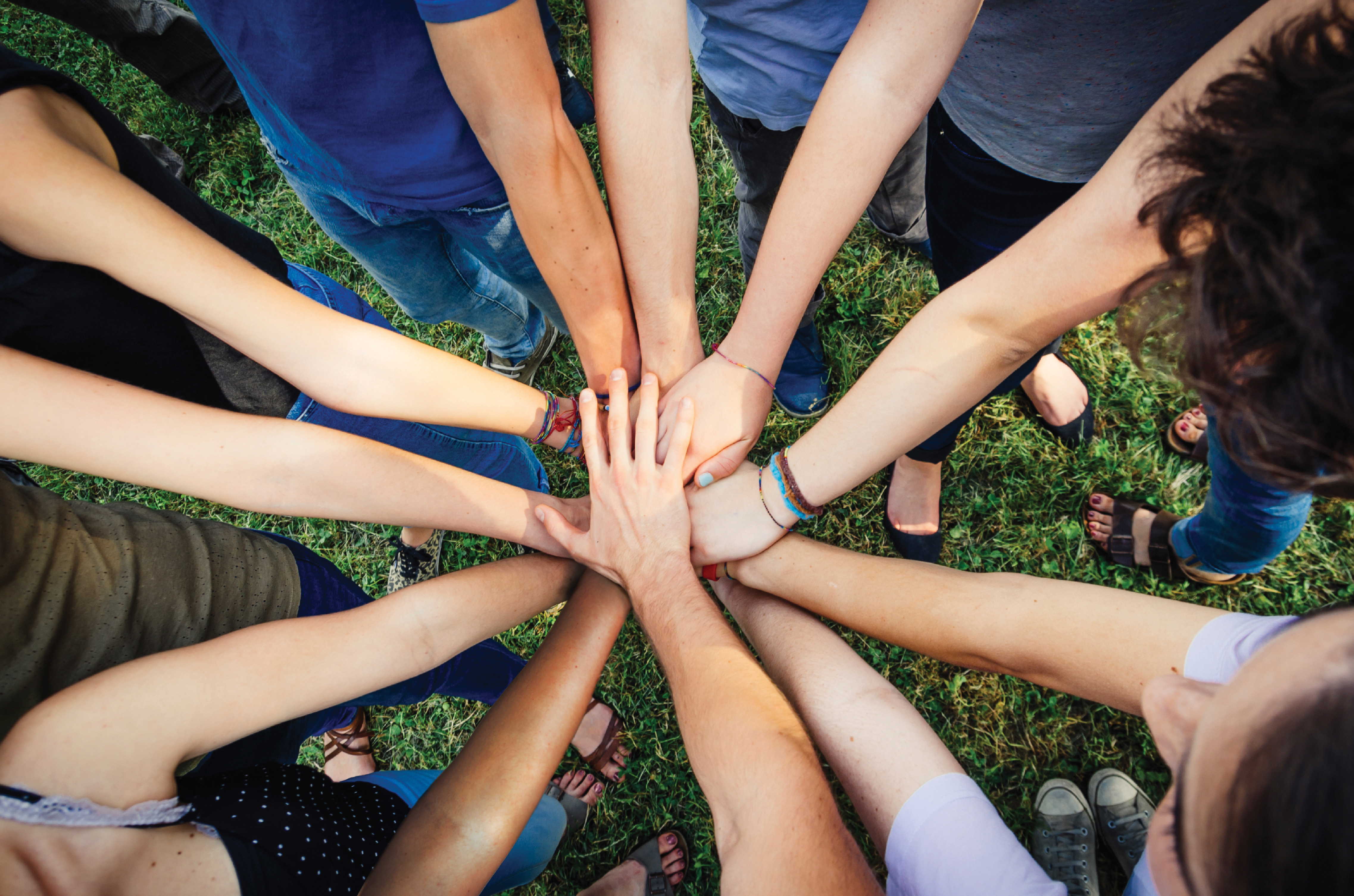 People's hands coming together