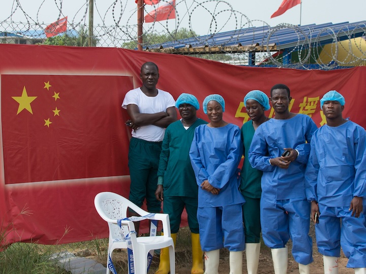 Ebola Response workers stand outside the Chinese Ebola treatment unit in Monrovia, Liberia. UNMEER/Simon Ruf/Flickr