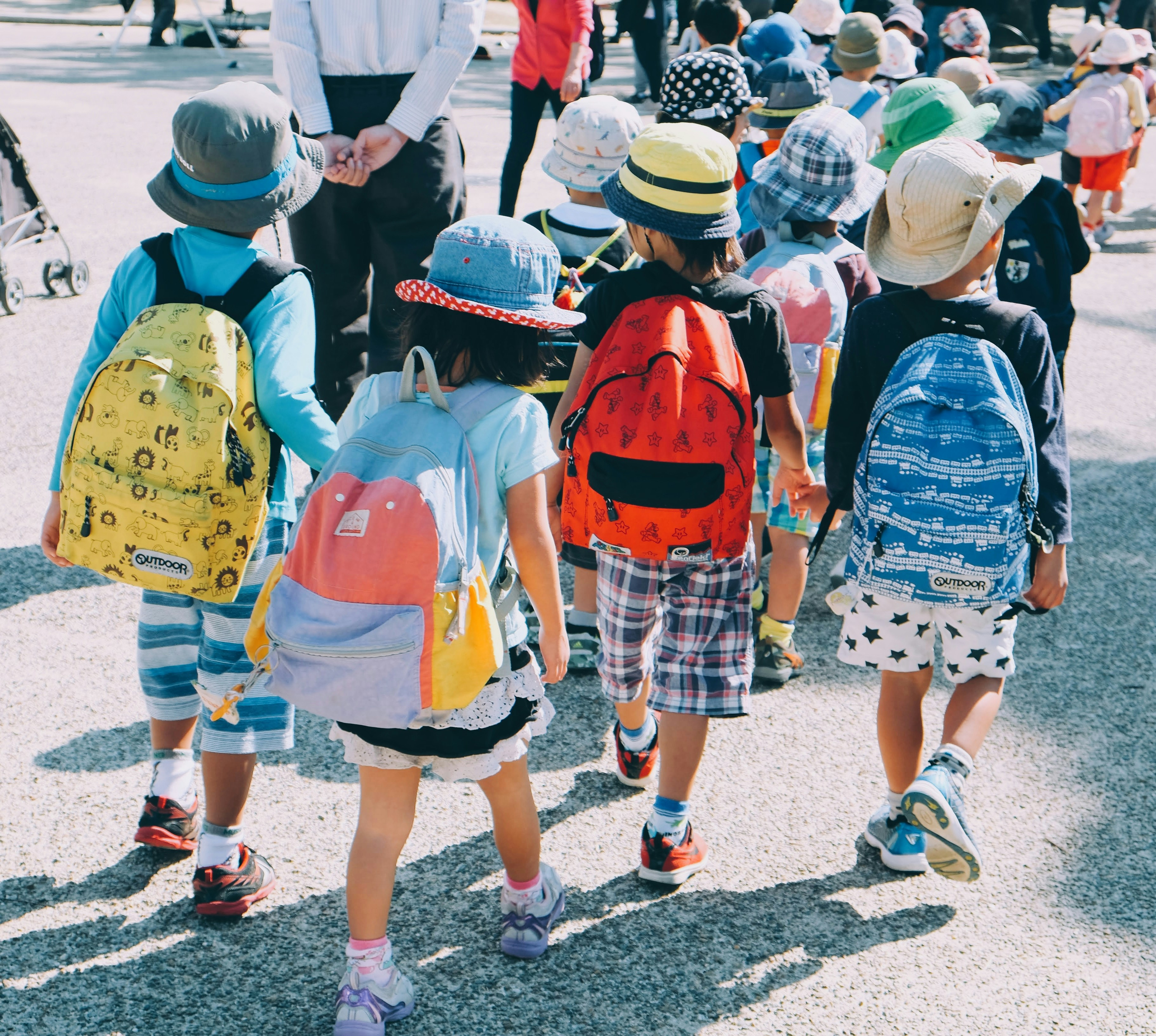 Several children walking with backpacks