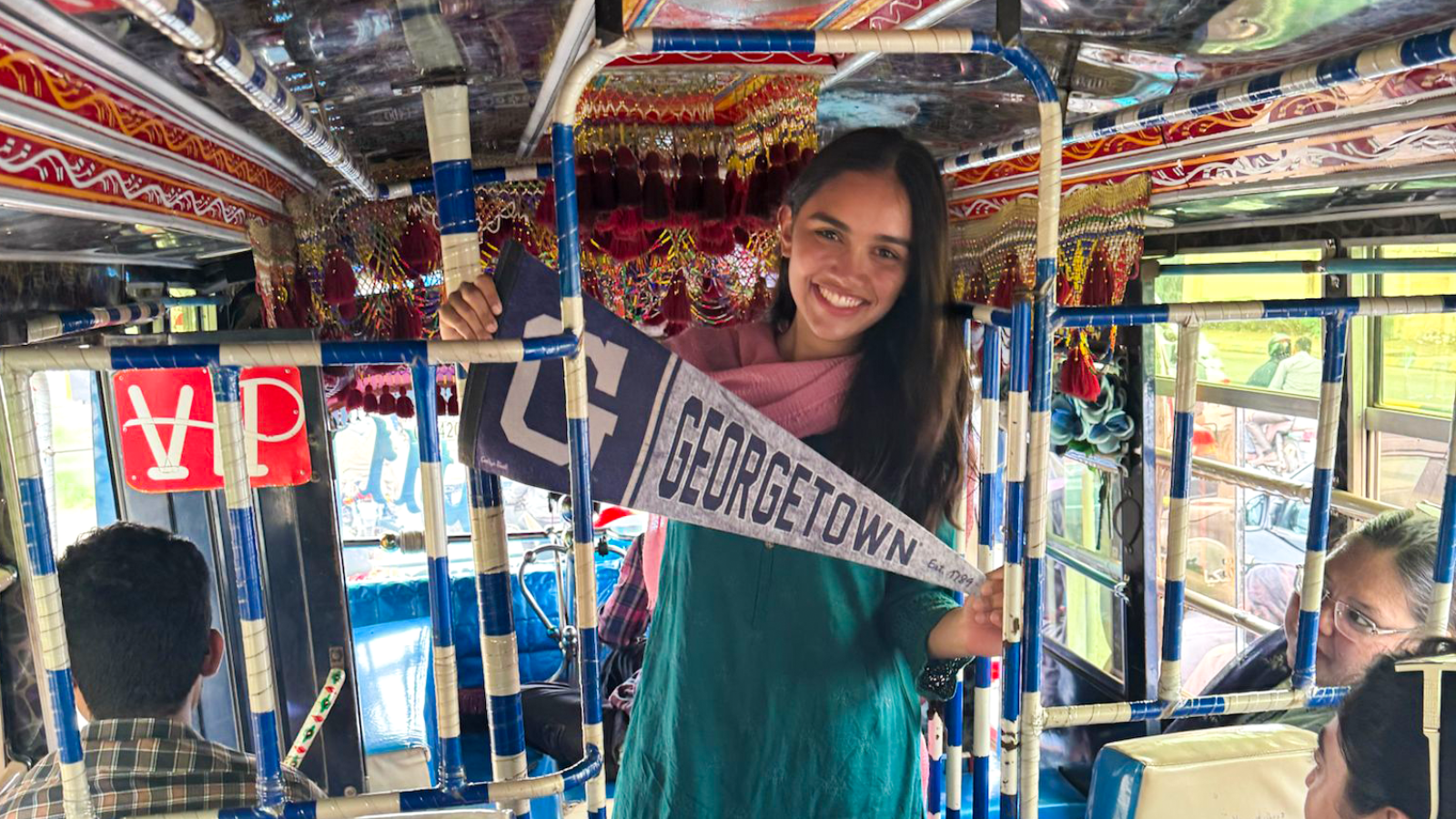 Amara Saleem holding a banner that reads "Georgetown"