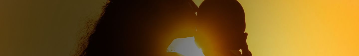 Woman embraces baby.