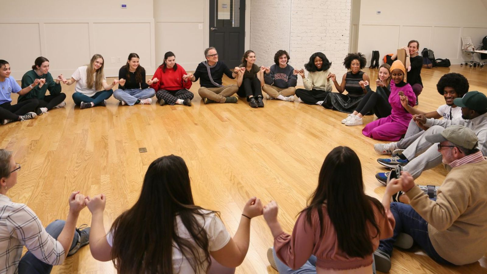 Participants sit in a circle during Ifrah Mansour and Emma Jaster's workshop "Healing with Humor"