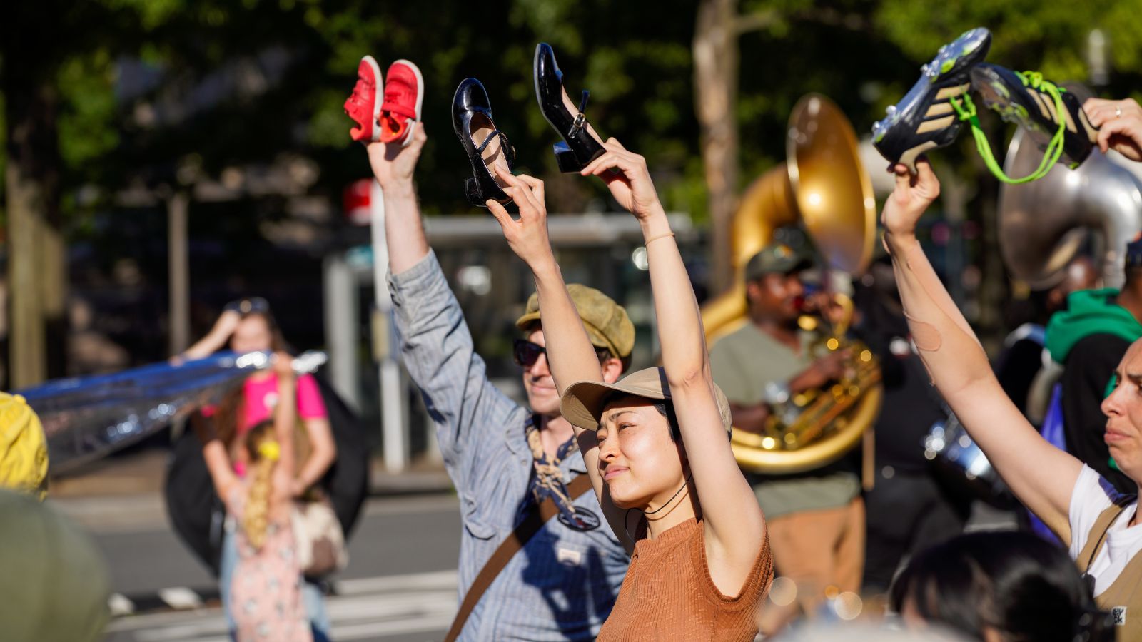 Performers hold up shoes to Amal