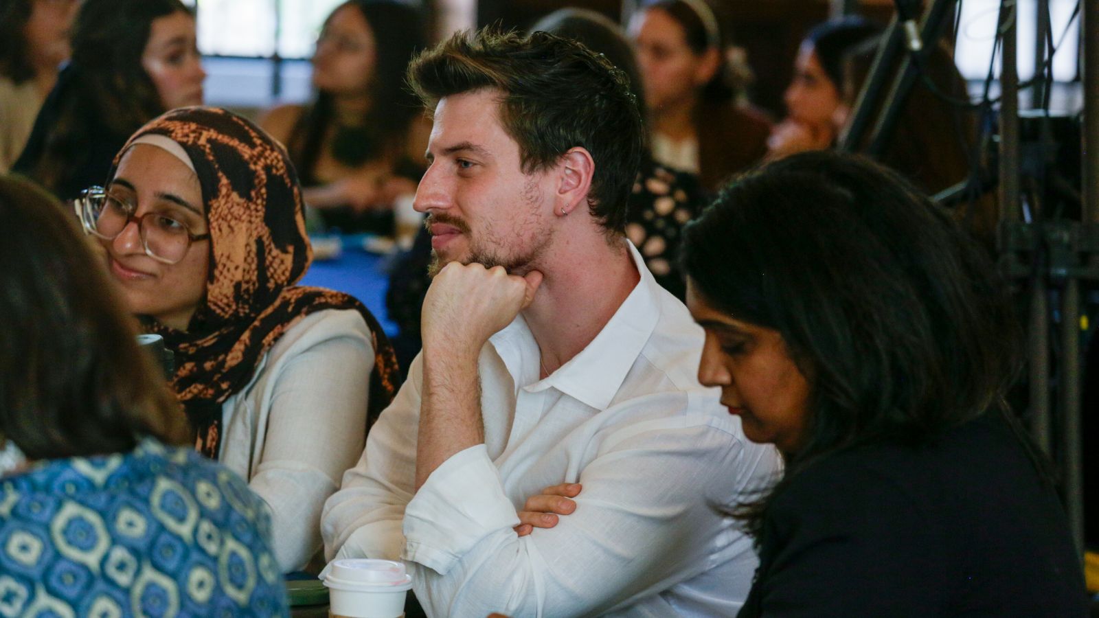 Three people focus on a conversation.