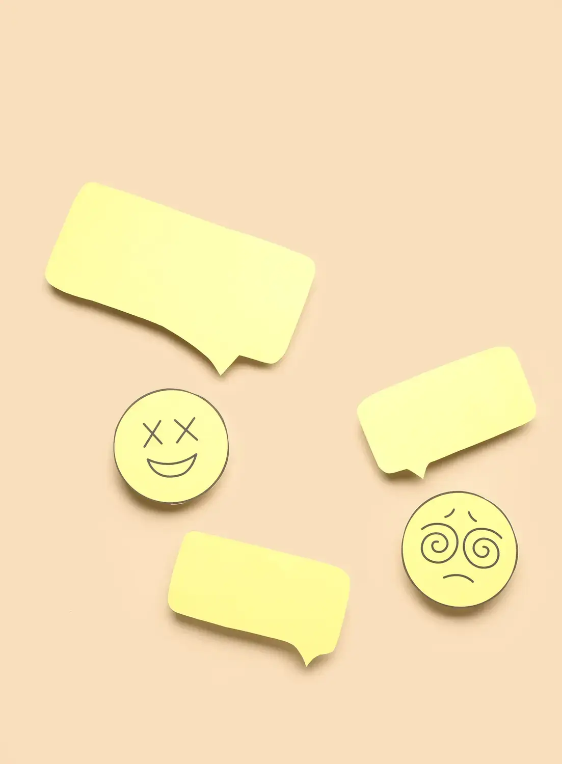 Colorful paper cutouts of speech bubbles and faces, representing interpersonal communication in live chat support.