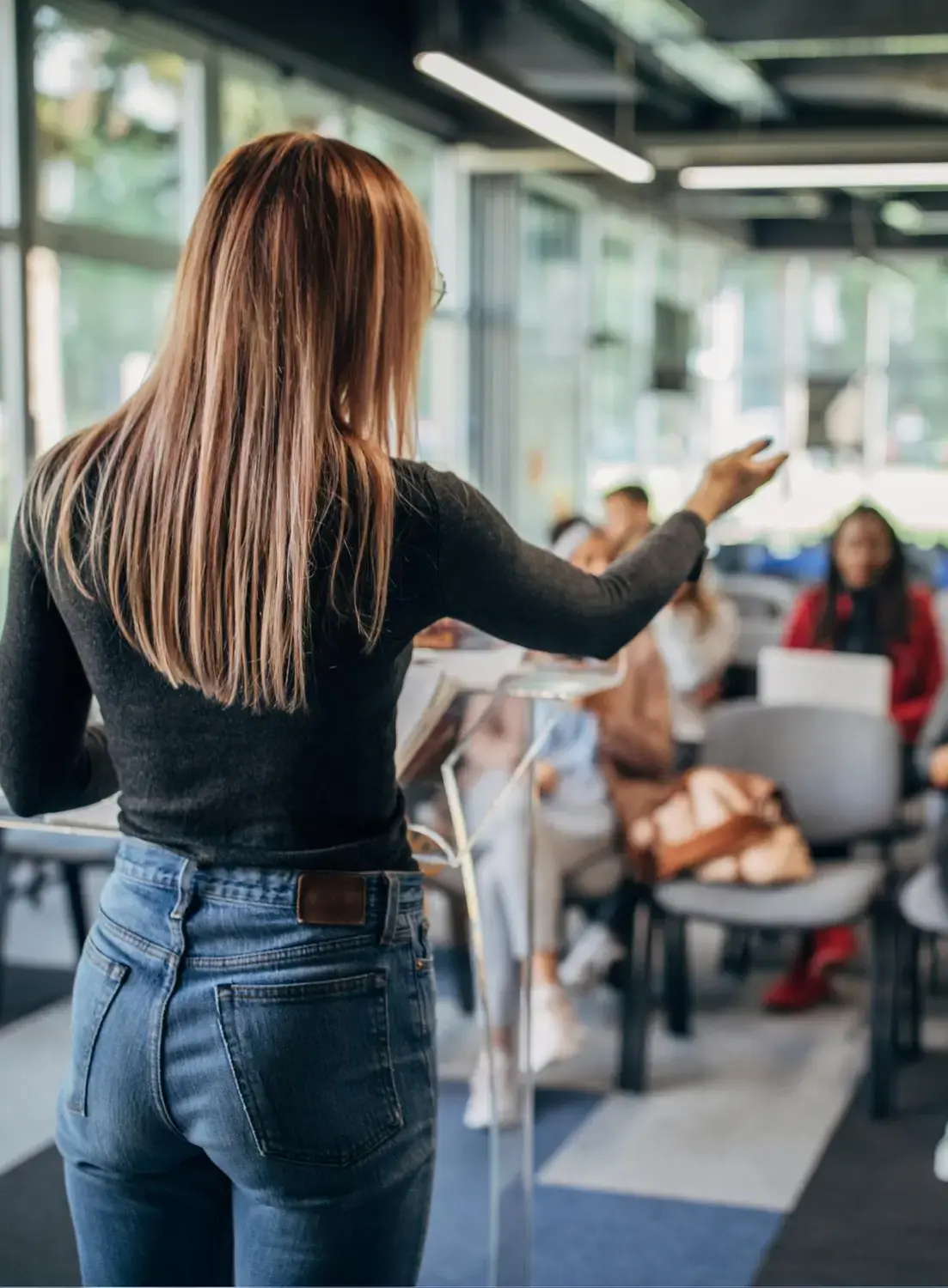 Woman leading a business coaching class, engaging participants and offering guidance to help them grow and succeed in their businesses.