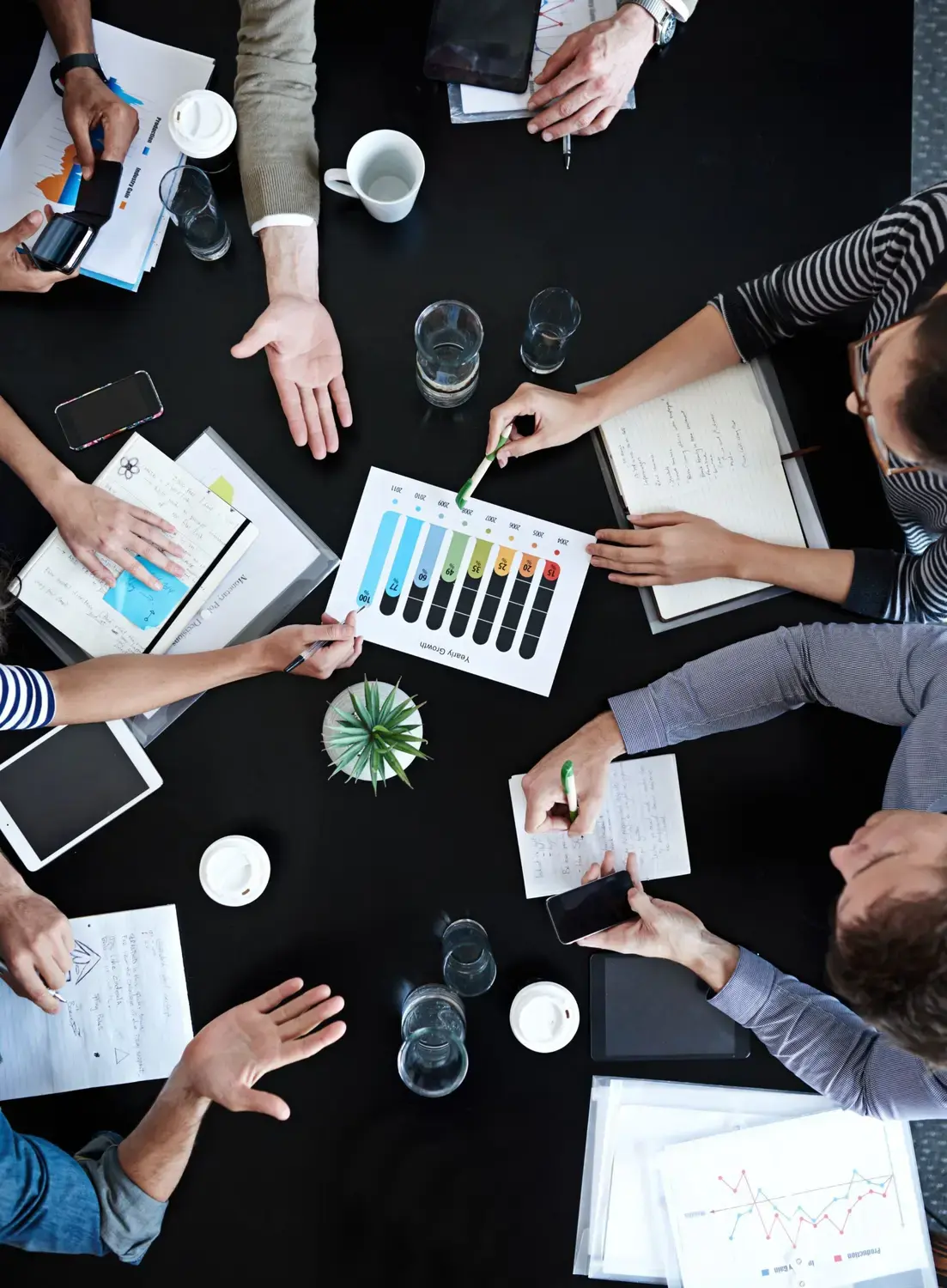 Group of professionals analyzing financial data for answering service expenses.