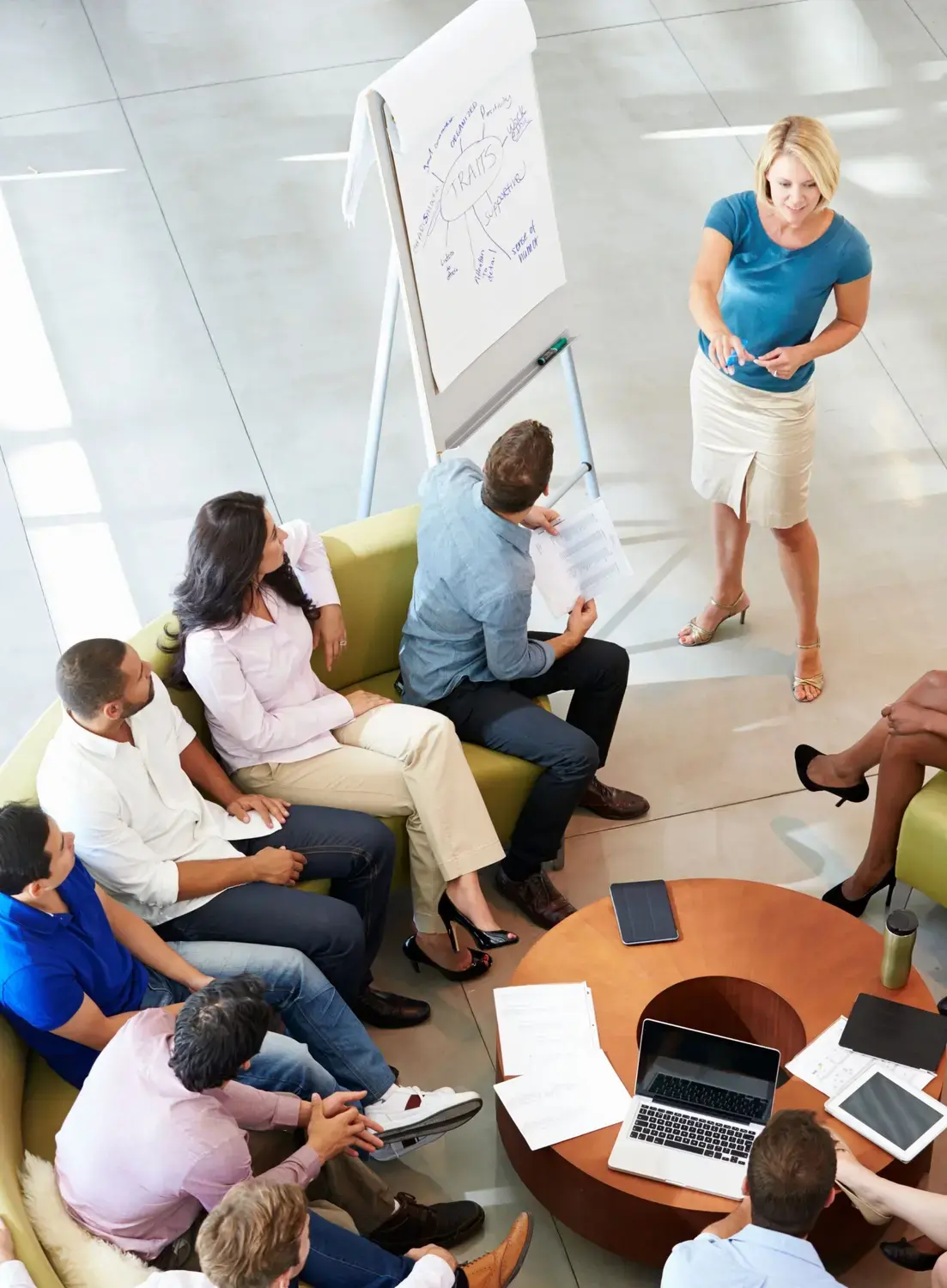 Woman presenting lead generation strategies to a sales team.