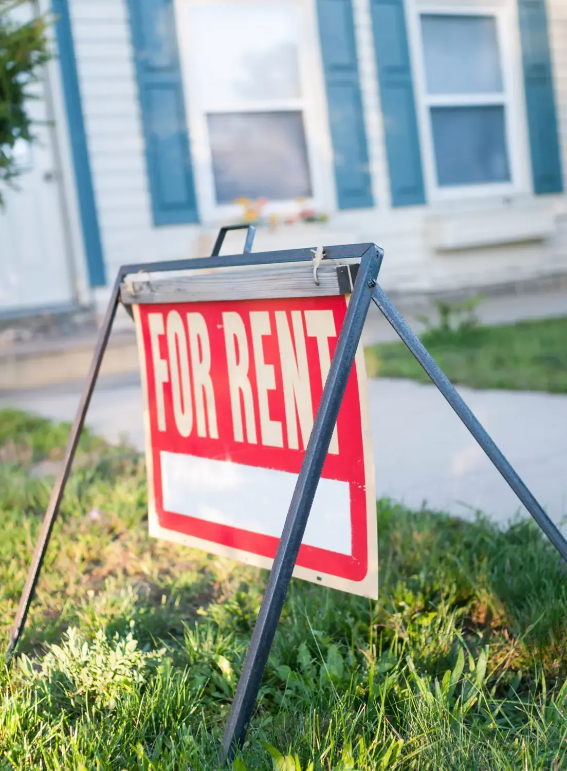 Dedicated answering service for property management inquiries. Bright 'For Rent' sign in front of a charming apartment.