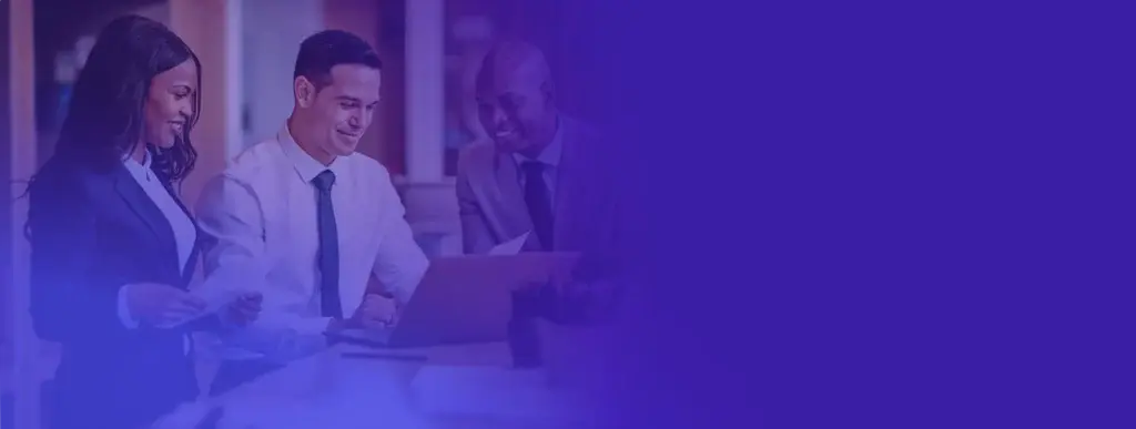 Professionals working around a laptop