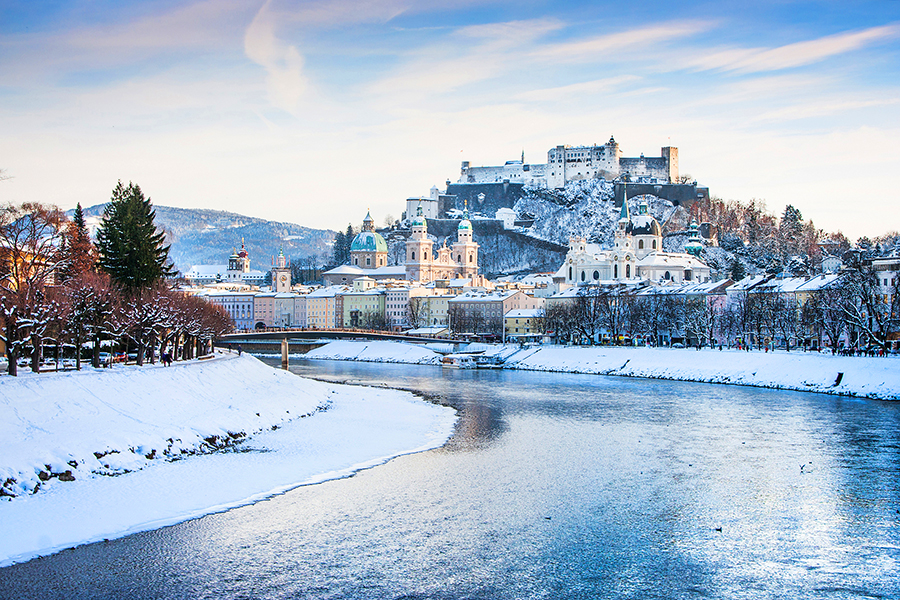 Vienna Christmas market in front of a palace lit up with holiday lights and festive stalls