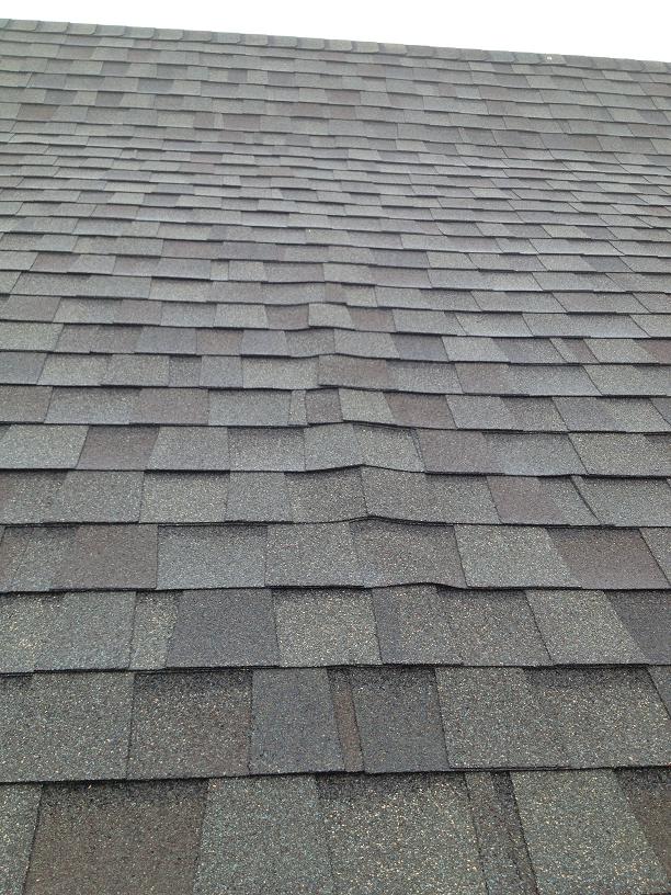 Asphalt shingles, synthetic underlayment, closedcell foam and buckled