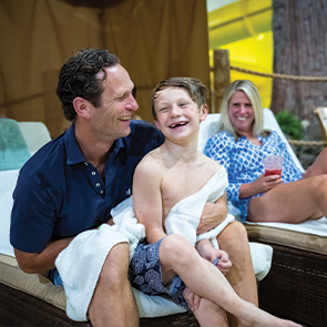 Young boy and dad drying off at the waterpark