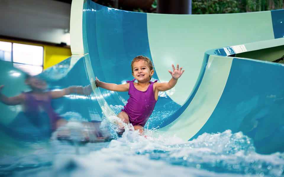 Young Girl Sliding Down Waterslide