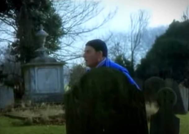 Fletch behind a grave