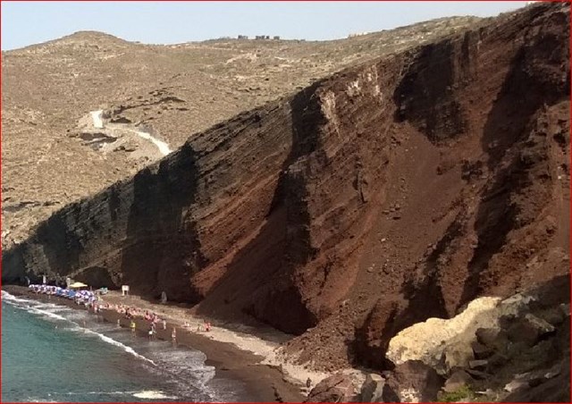 Diagonal stripes in the cliff indicate different layers/eruptions.