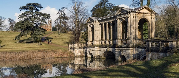 Stowe view, the Gothic Temple beyond a pretty bridge in sunshine