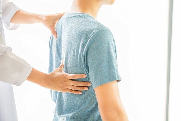 close-up-of-physiotherapist-working-with-patient-in-clinic