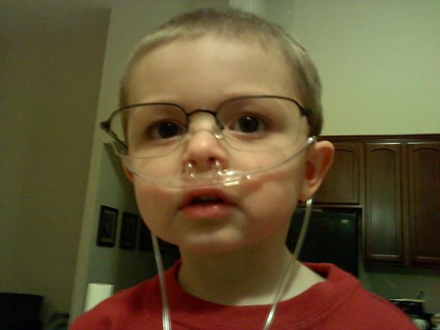 Grandson 2, with papa bill's tube and glasses