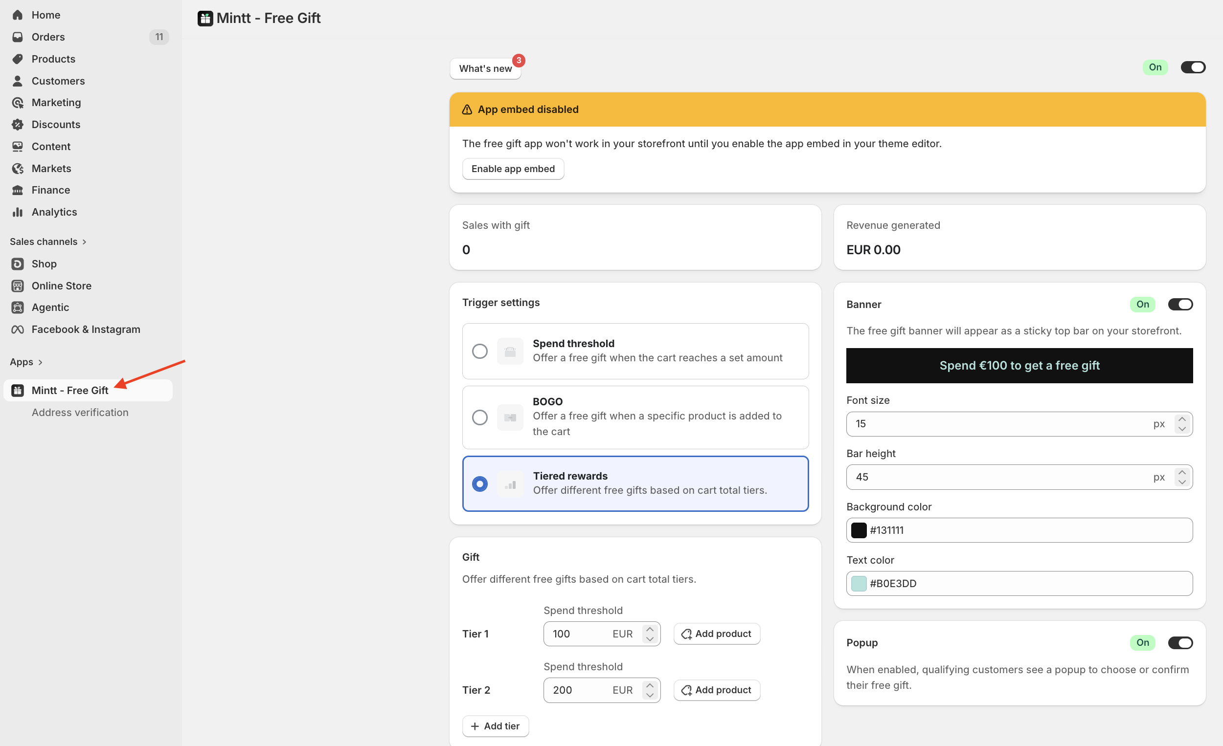 Shopify admin with a red arrow pointing to the Mintt - Free Gift app