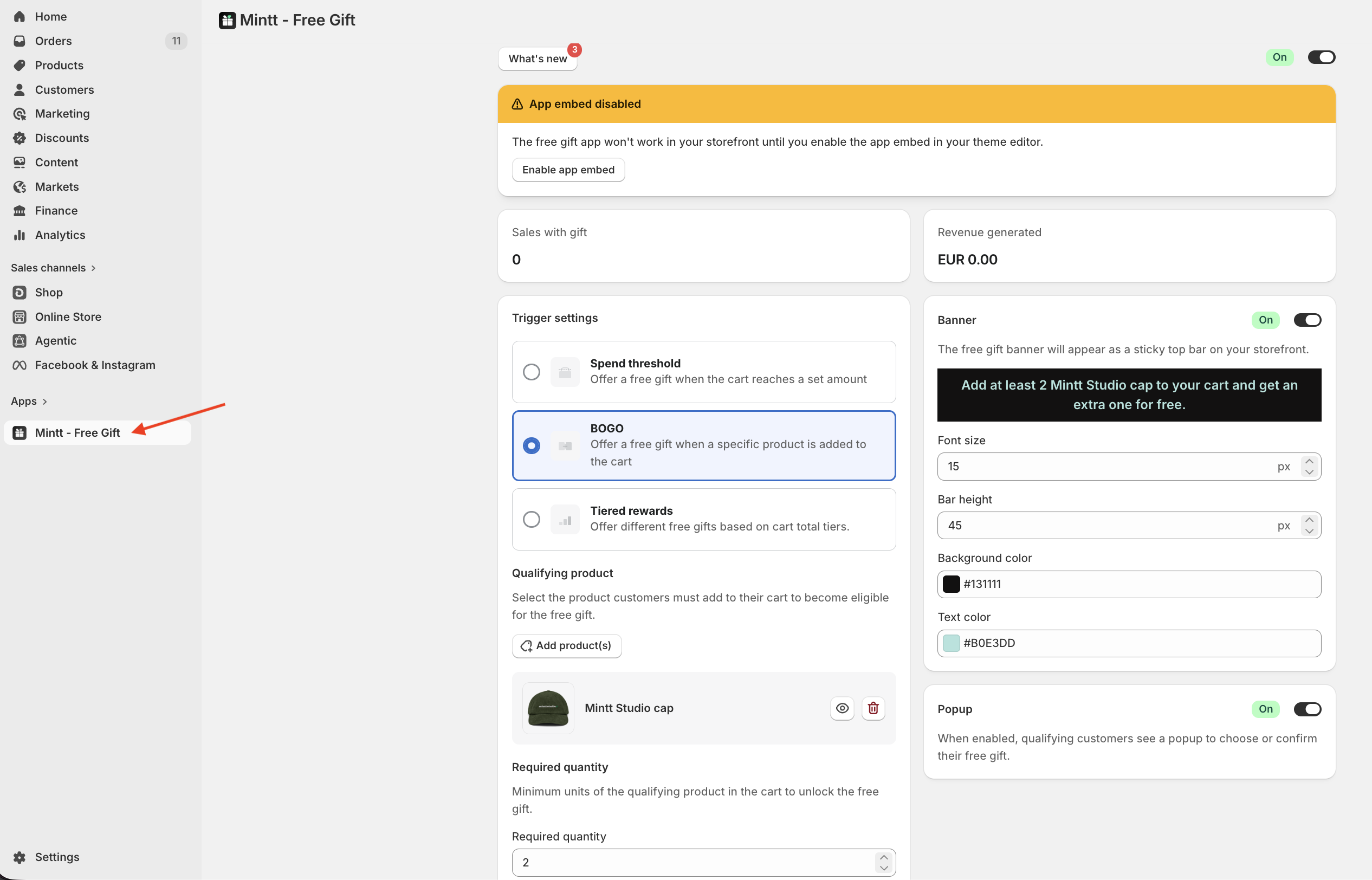 Shopify admin with a red arrow pointing to the Mintt - Free Gift app