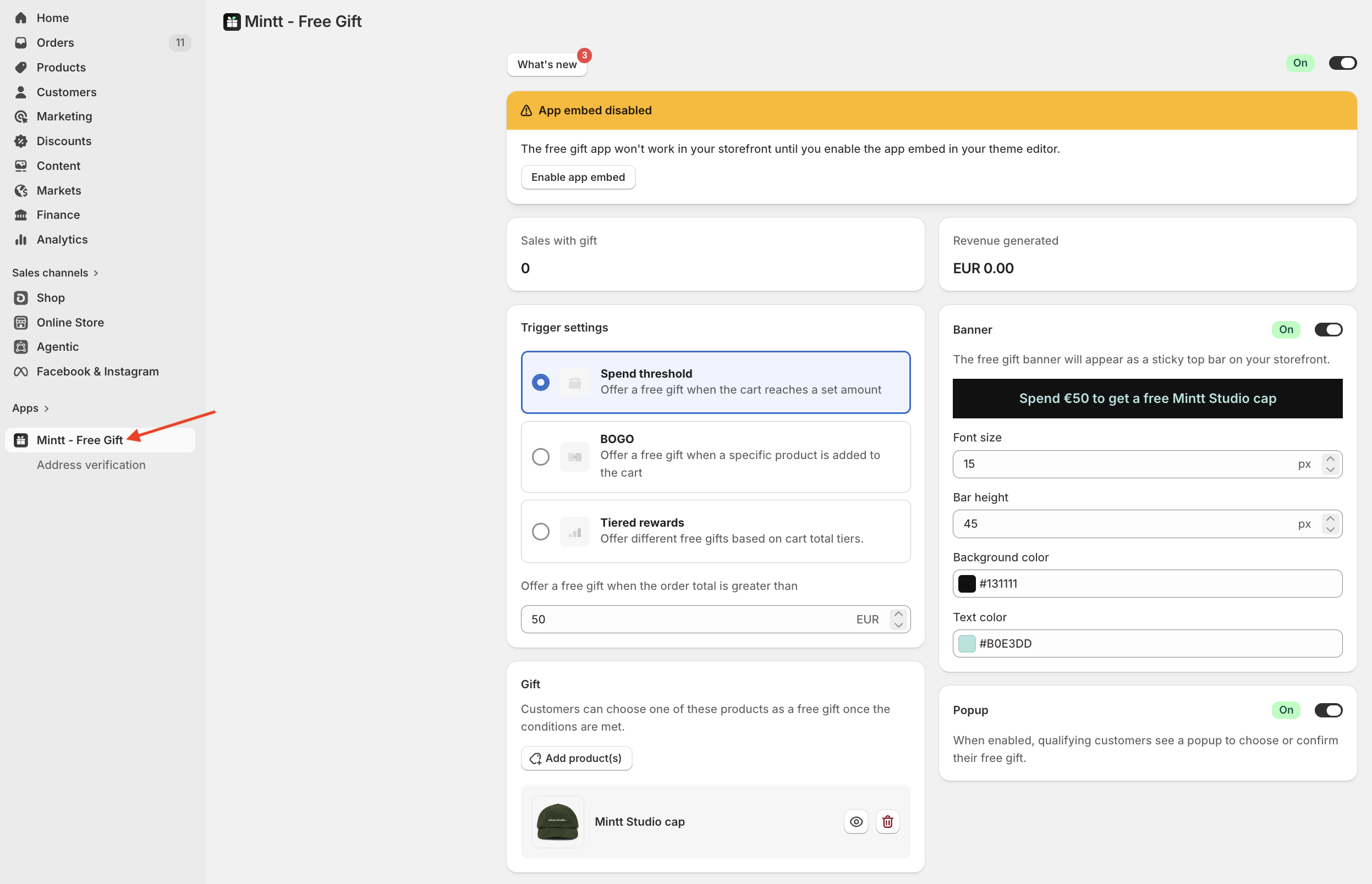 Shopify admin with a red arrow pointing to the Mintt - Free Gift app