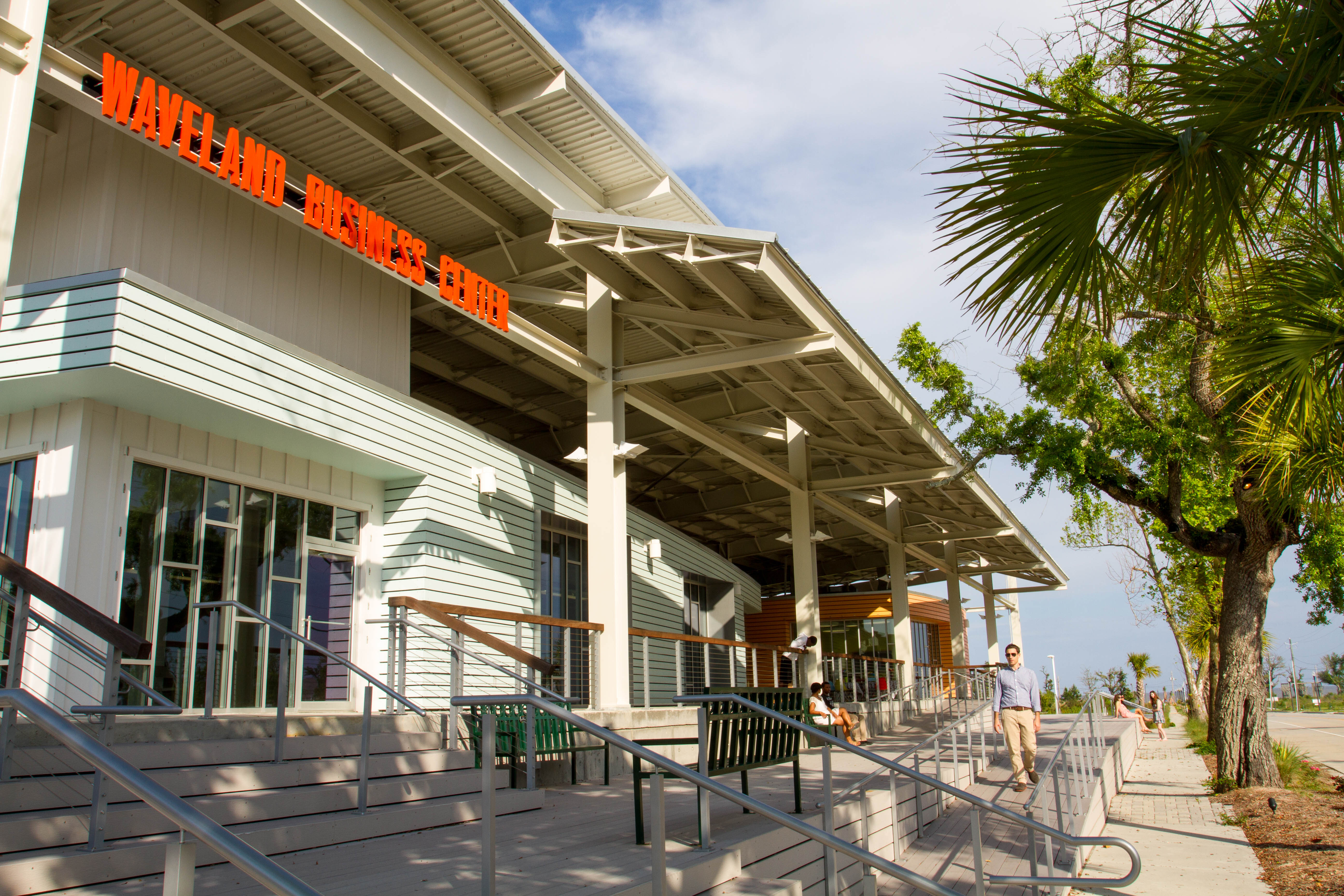 The Waveland Business Center in Bay St. Louis, Mississippi, by unabridged Architecture, is elevated above the coastal floodplain to provide additional protection against storm surge and sea level rise. A double roof system provides redundant protection from intense rainfall and allows people to circulate outside. Photo: Eugenia Uhl