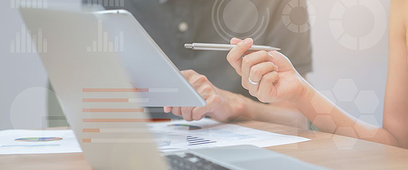 Two people are discussing a piece of paper.