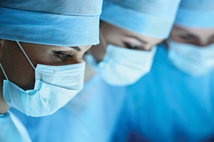 three female medical professionals wearing surgical masks