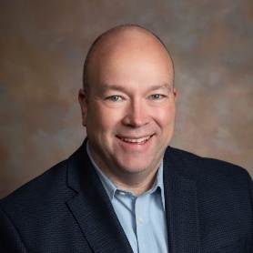 A person in a suit smiling

AI-generated content may be incorrect.