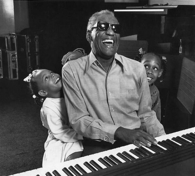 Singer Ray Charles with granddaughters in his home studio, LA