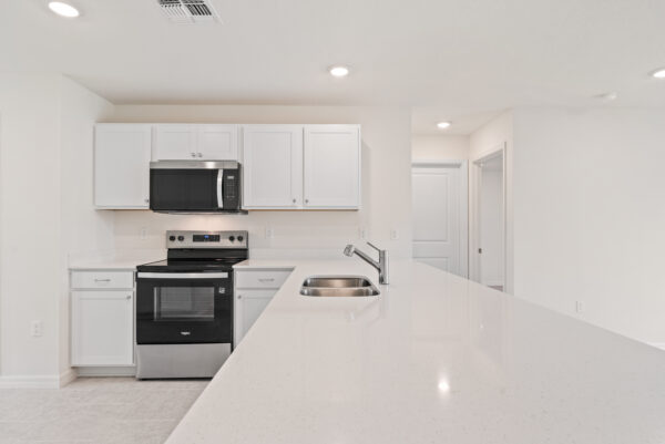 The White Quartz Countertops in the Kitchen of the Foxtail from the Value Collection