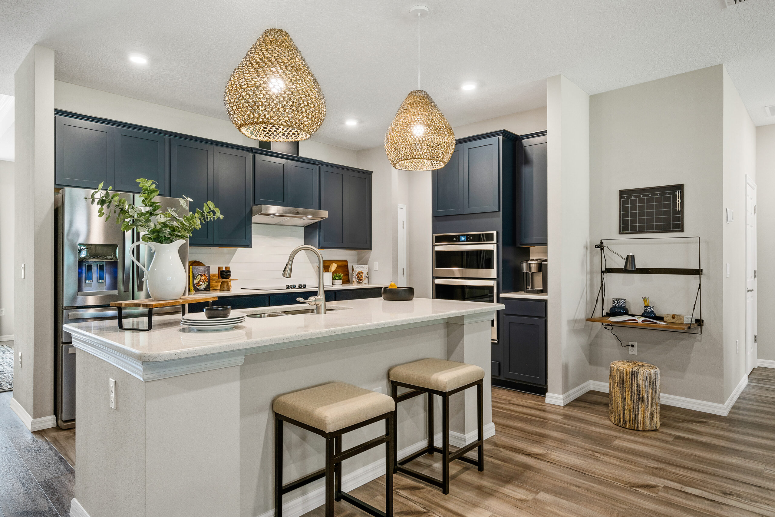 Beautiful blue cabinet kitchen in the Captiva floorplan from the Cornerstone collection by Holiday Builders.