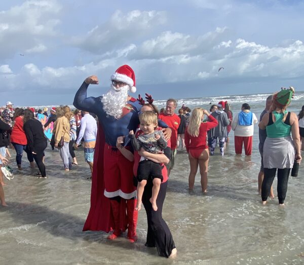 A photo of people in holiday costumes on the beach