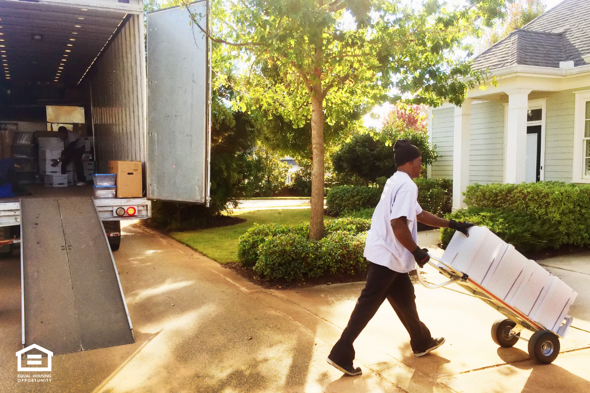 a man with a handcart moving boxes