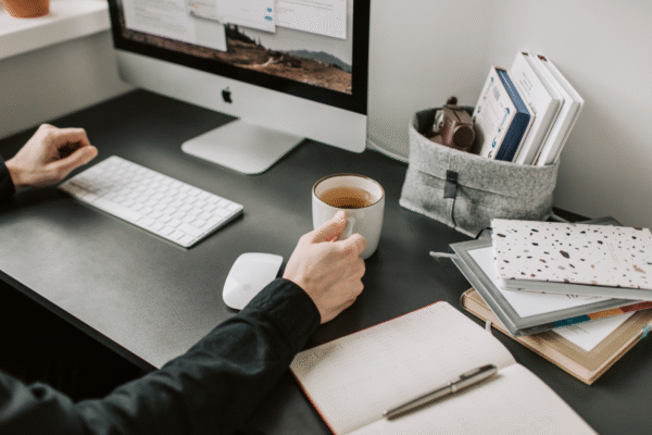 A person sitting at a desk with a computer