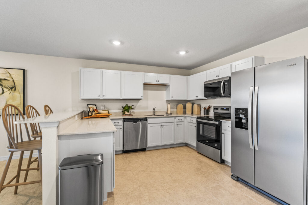 The Large Kitchen with Tile Flooring and White Quartz Countertops in the King Floorplan from the Value Collection