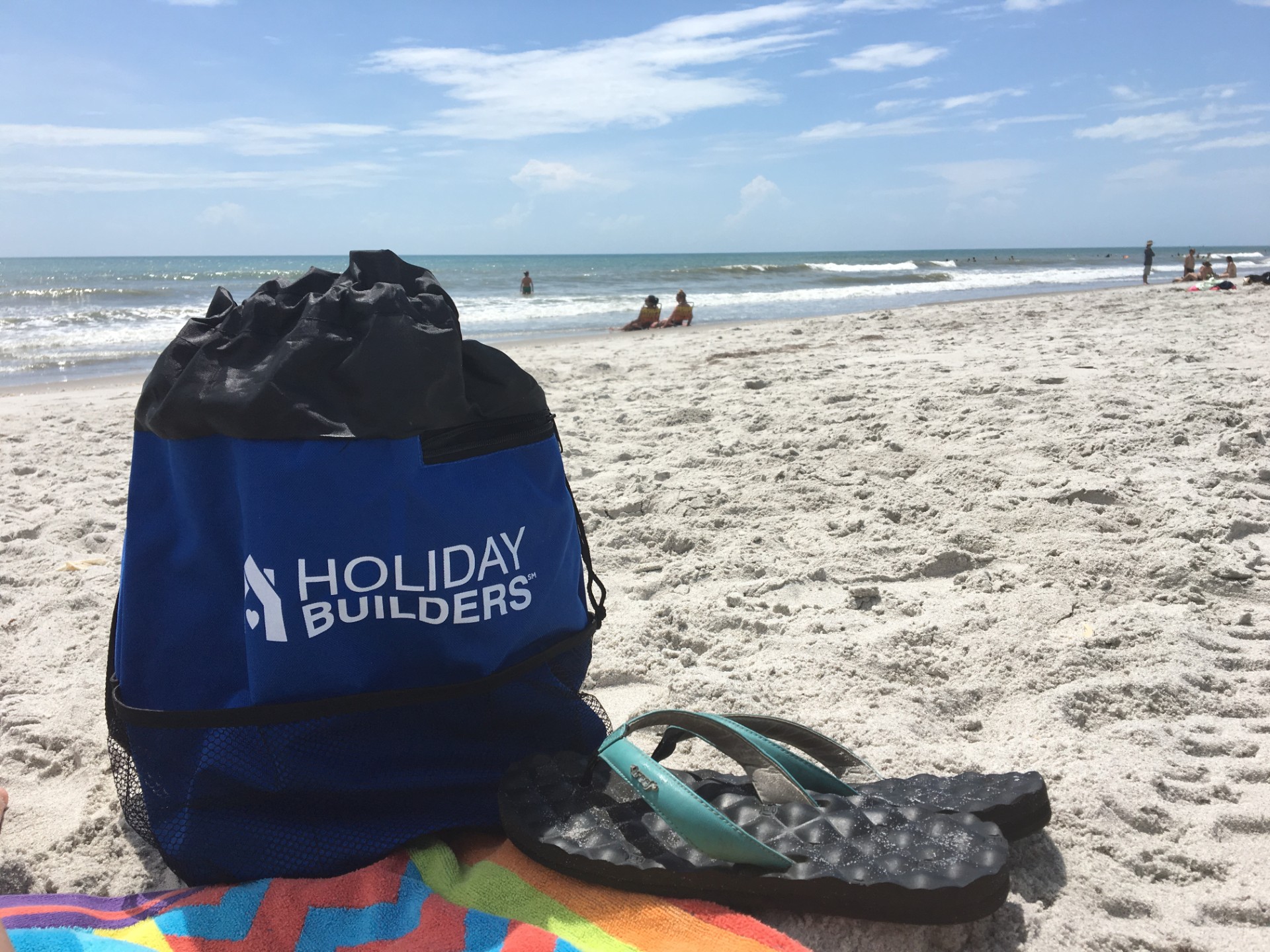 Holiday Builders' beach bag on beach