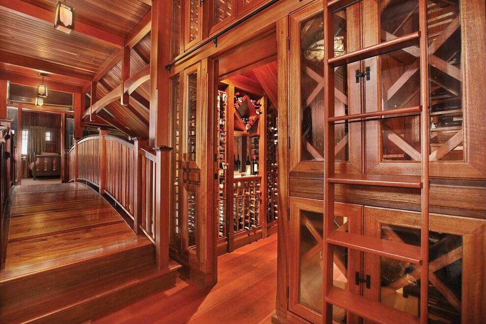 CLWCTT Incredible woodwork is the highlight of this wine storage room which includes a ladder for reaching wines. Wooden bridge provides access to the closed-off wine storing room.